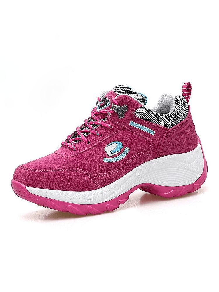 Magenta women's sneakers with suede uppers, lace-up closure, and white sole, designed for comfort and stability in sports.